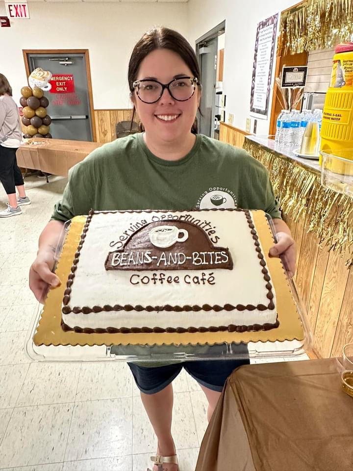 Brittany with cake with logo